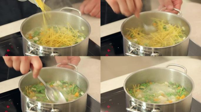 厨师正在将意大利面放入沸腾的蔬菜汤中