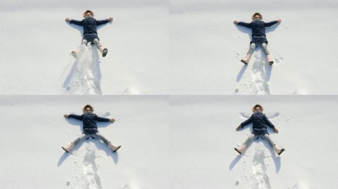 一个女孩做雪天使的俯视图