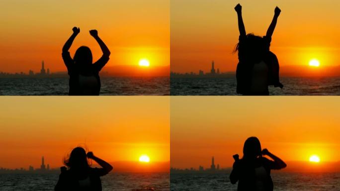 兴奋的女人在日落时跳跃庆祝成功