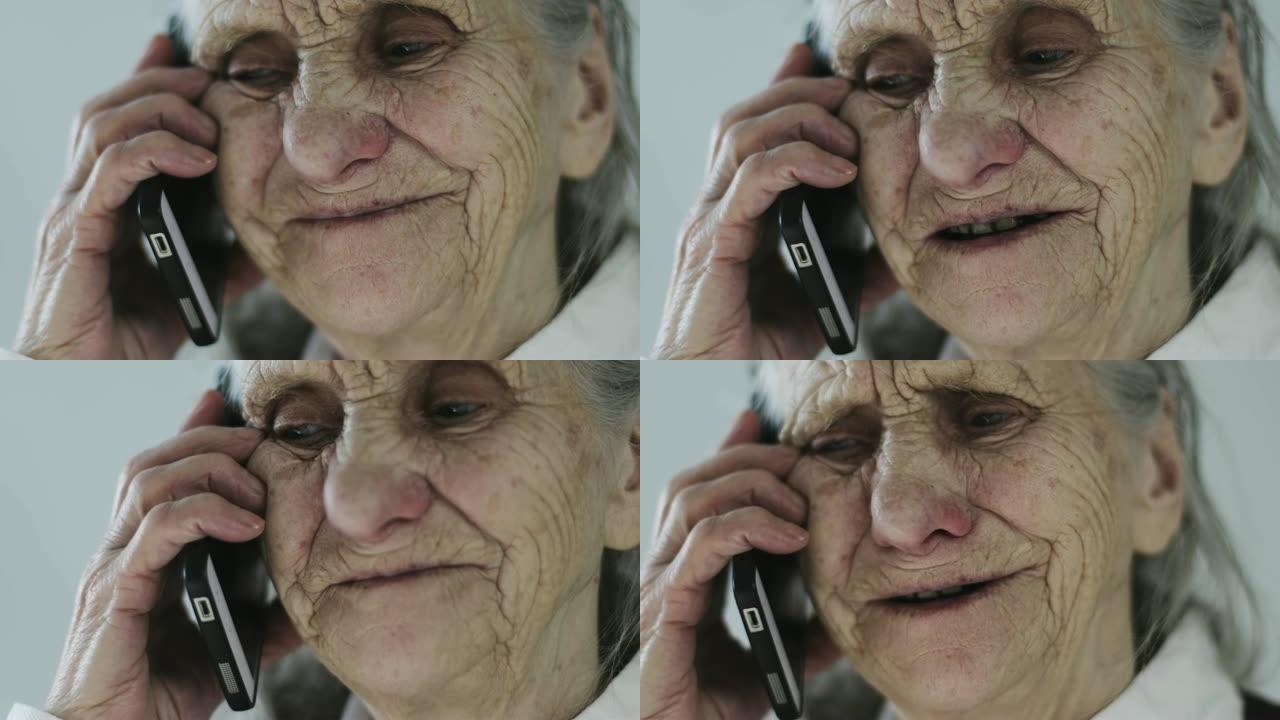 一个有着深深的皱纹的祖母在手机上说话的特写脸。