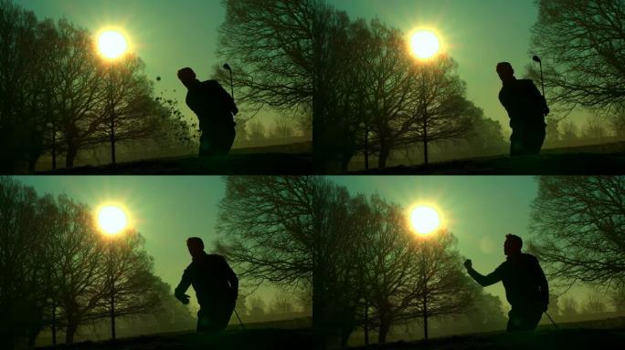 一名高尔夫球手在日出时从沙坑中打出一记好球。