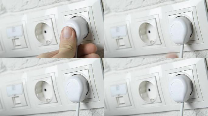 用手将电气插头插入墙壁插座。