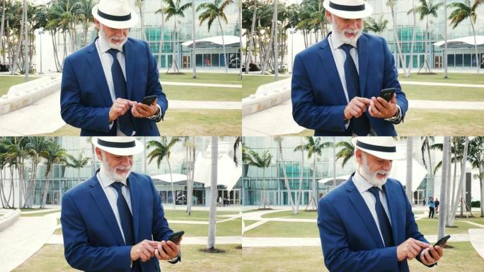 美国公园高级拉丁绅士使用智能手机的肖像