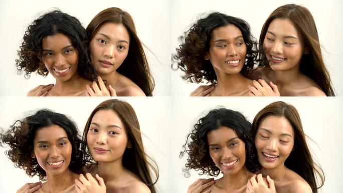 亚洲美丽的棕褐色和白人妇女的头发是白色背景上的运动和微笑。拥有美丽、医疗保健、情感概念的人。
