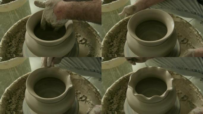 陶工用泥或陶土完成一个新瓷瓶的口部造型