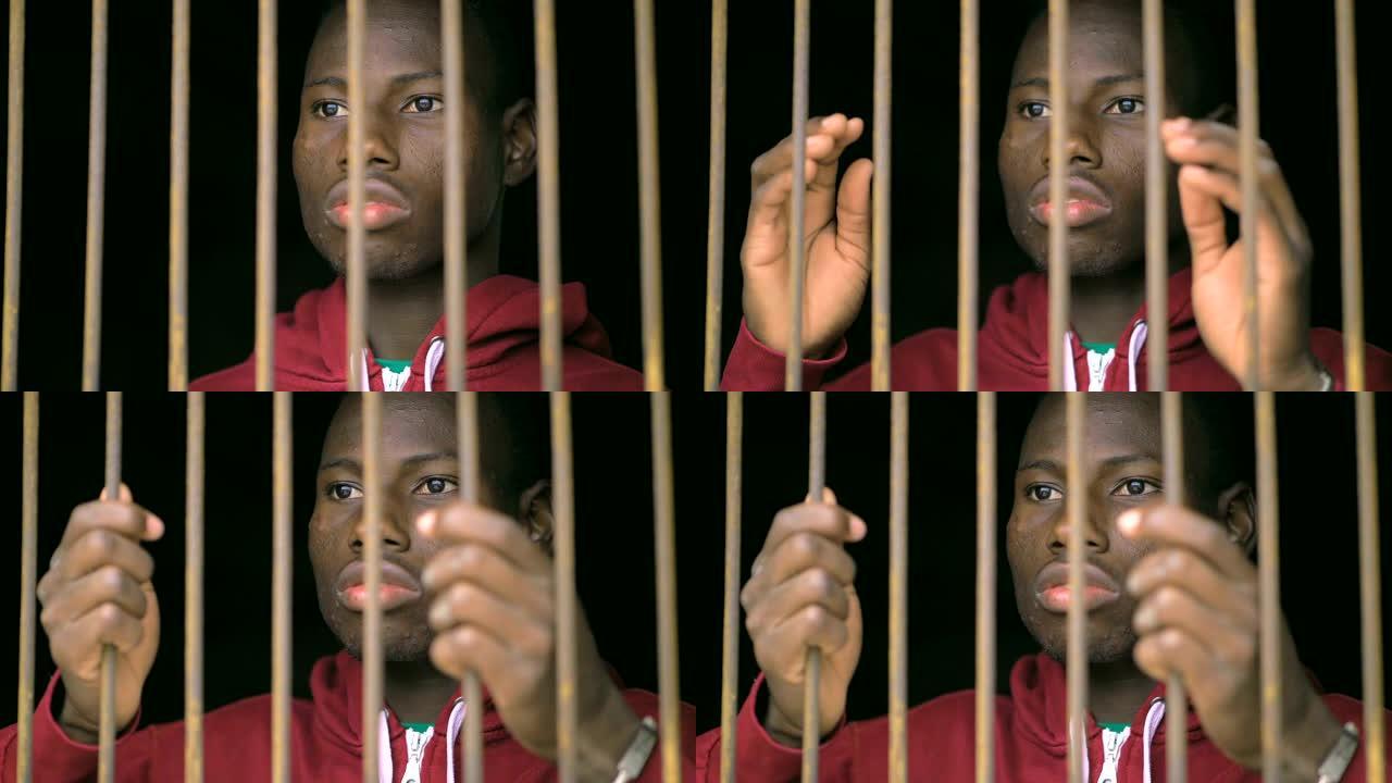 非法移民，监狱。悲伤的年轻黑人非洲移民在监狱里-慢动作