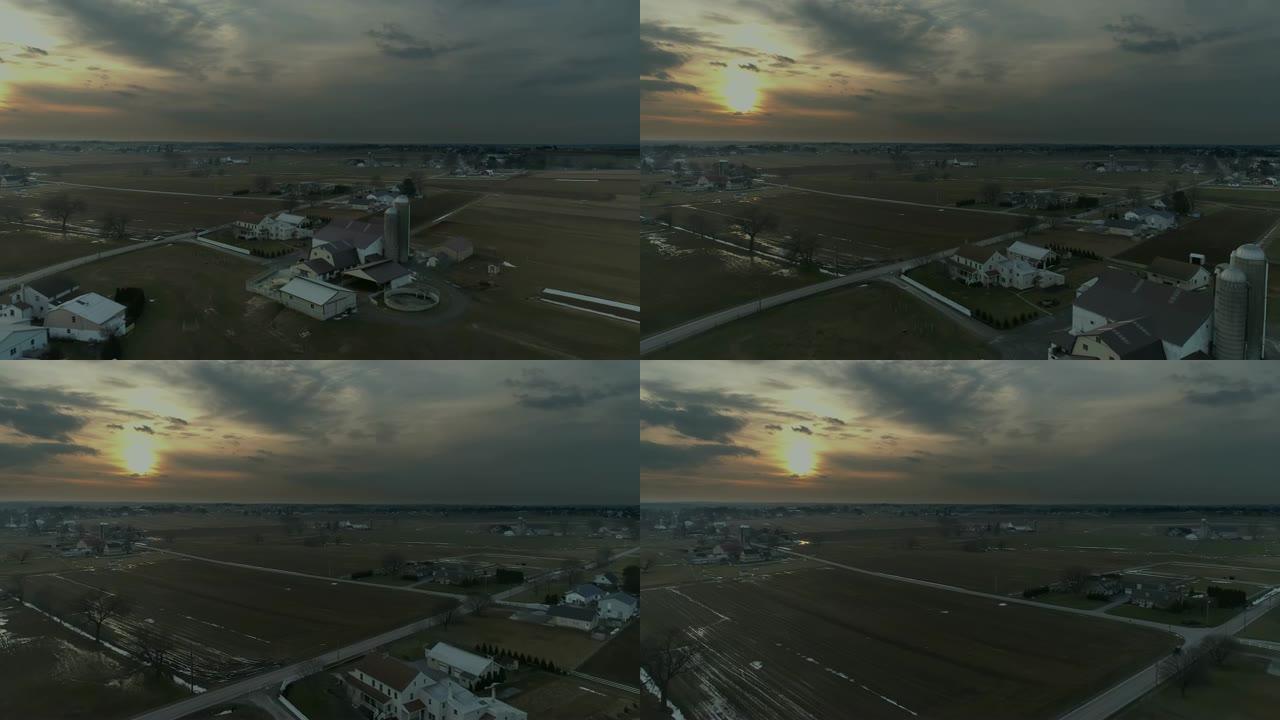 无人机在暴风雨的冬日日落时对阿米什人农田的鸟瞰图