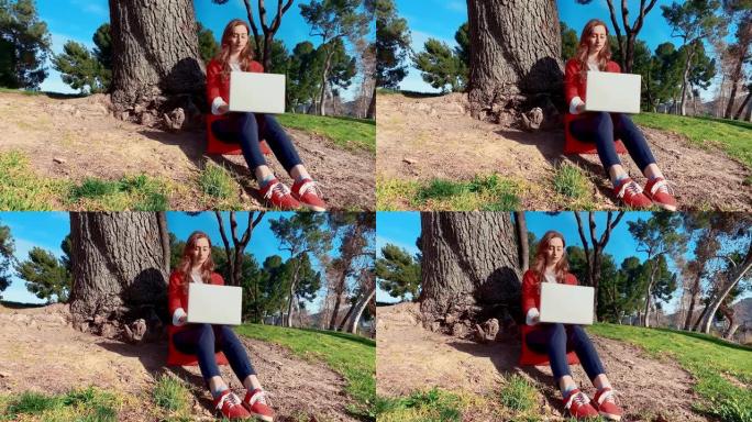 年轻女子在树下的笔记本电脑上打字-中性表情-斯坦尼康-宽-没有标志