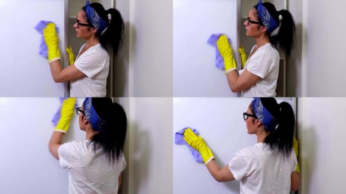 女性清洁工擦拭家具门