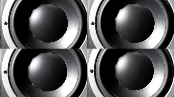 录音棚上移动专业低音炮的特写。黑色圆形音频扬声器从低频声音中脉动和振动。高保真扬声器薄膜的工作。慢动