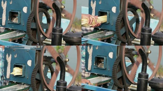 一台电机将甘蔗榨汁的镜头