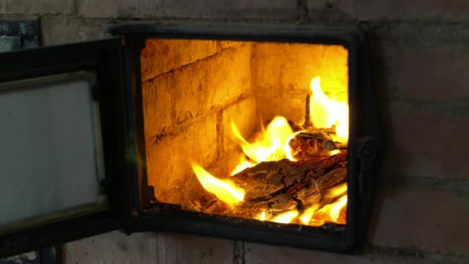 在村舍的烤箱里烧木头