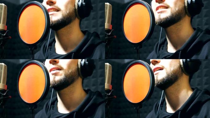 耳机男歌手的嘴在sound studio的麦克风中唱歌。年轻人在情感上录制新歌。创意音乐家的工作。展