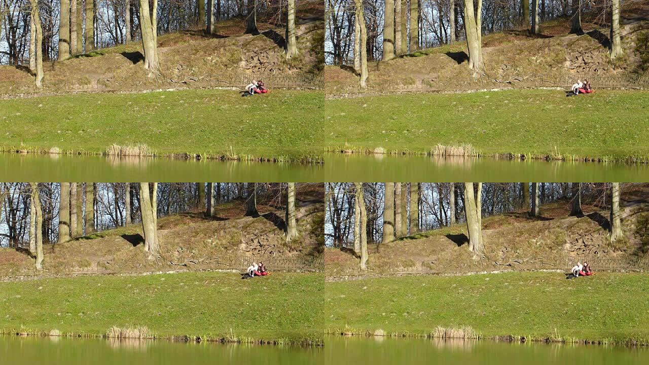 成熟的夫妇在池塘旁的公园放松