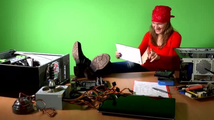 粗心的工程师女人，腿在桌子上玩平板电脑