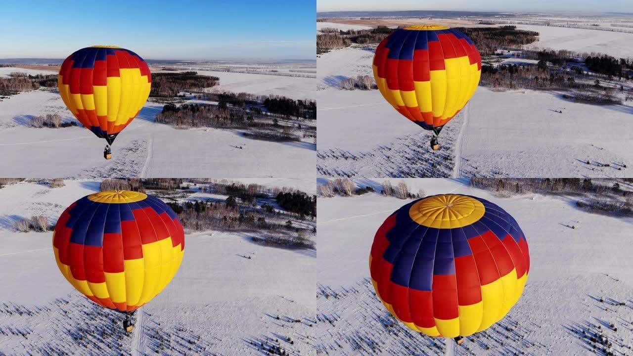空中拍摄的人在一个明亮的大气球上飞行。