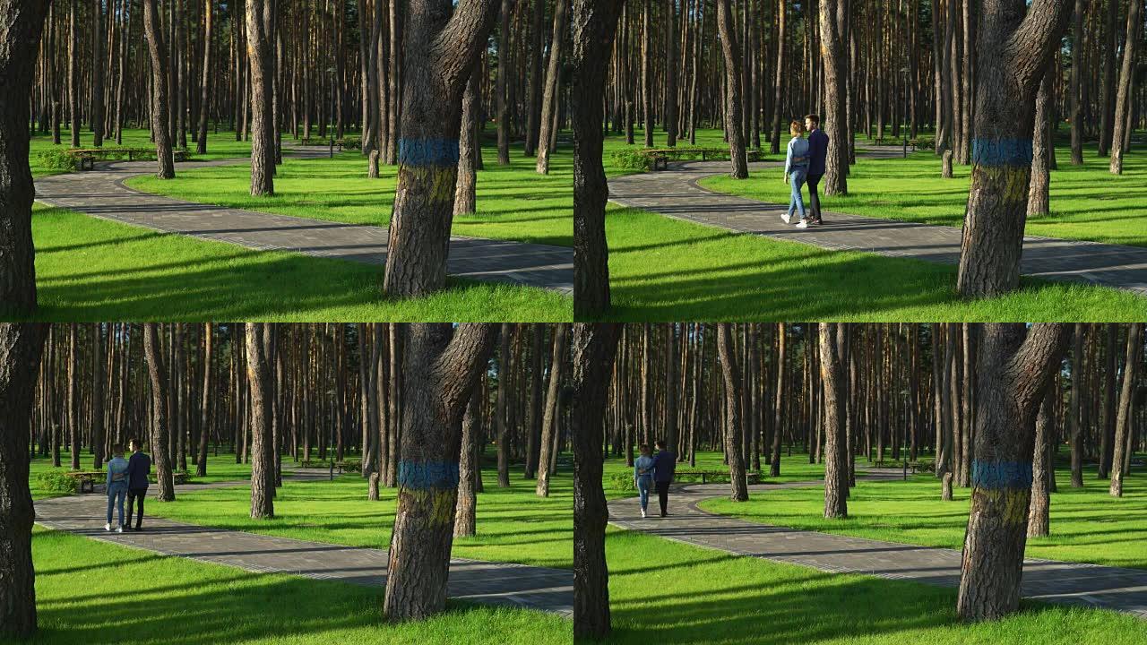 一家人沿着绿色的草坪和松树走