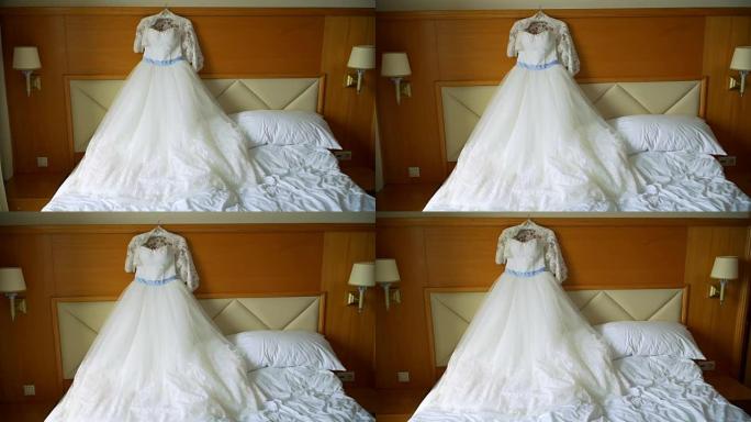优雅的婚纱躺在酒店房间的床上