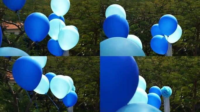 蓝色派对气球漂浮在户外露台上，庆祝活动充满乐趣和明亮的一天