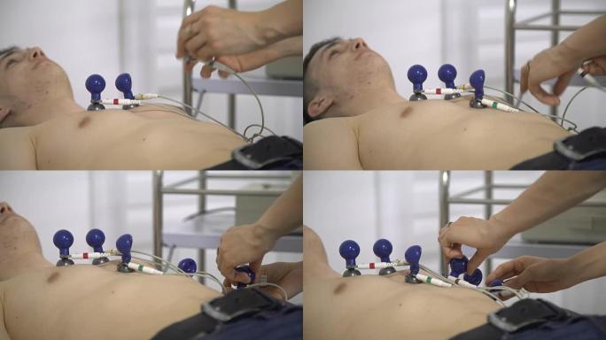 男性患者躺在病房附近进行心电图检查