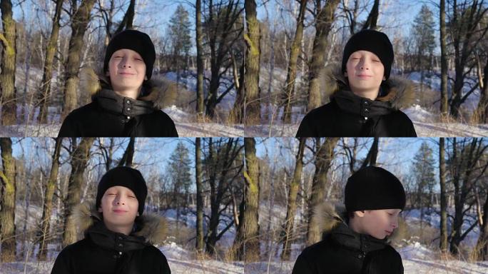 一个十几岁男孩的肖像特写。这个男孩做了一张严肃的脸。森林里阳光明媚的冬夜。强风。