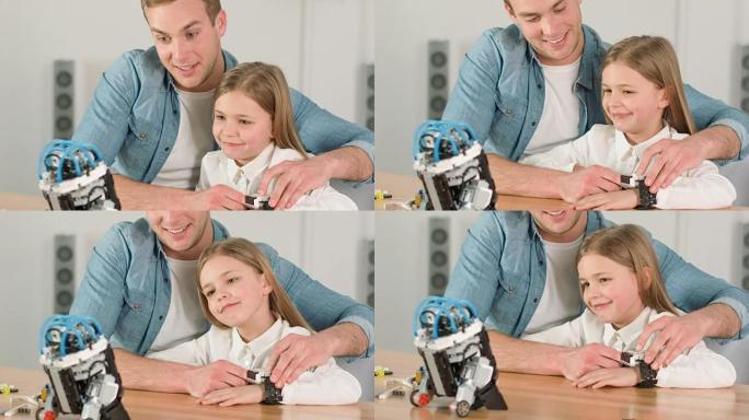 慈爱的父亲和他的女儿玩机器人玩具