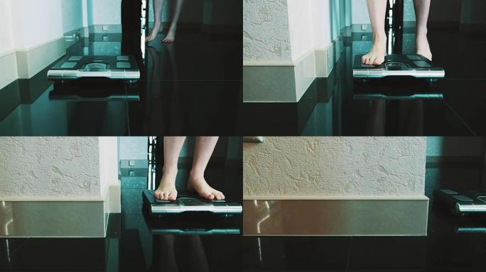 女孩走在地板上，站在公寓里的现代天平上。称重。苗条