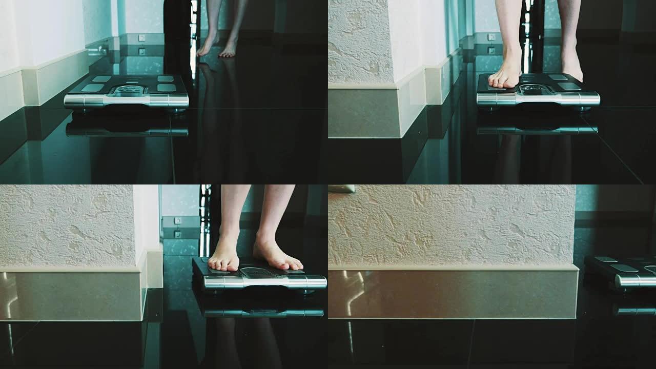 女孩走在地板上，站在公寓里的现代天平上。称重。苗条