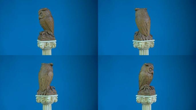 木制猫头鹰雕塑在古董柱模型上旋转，4K