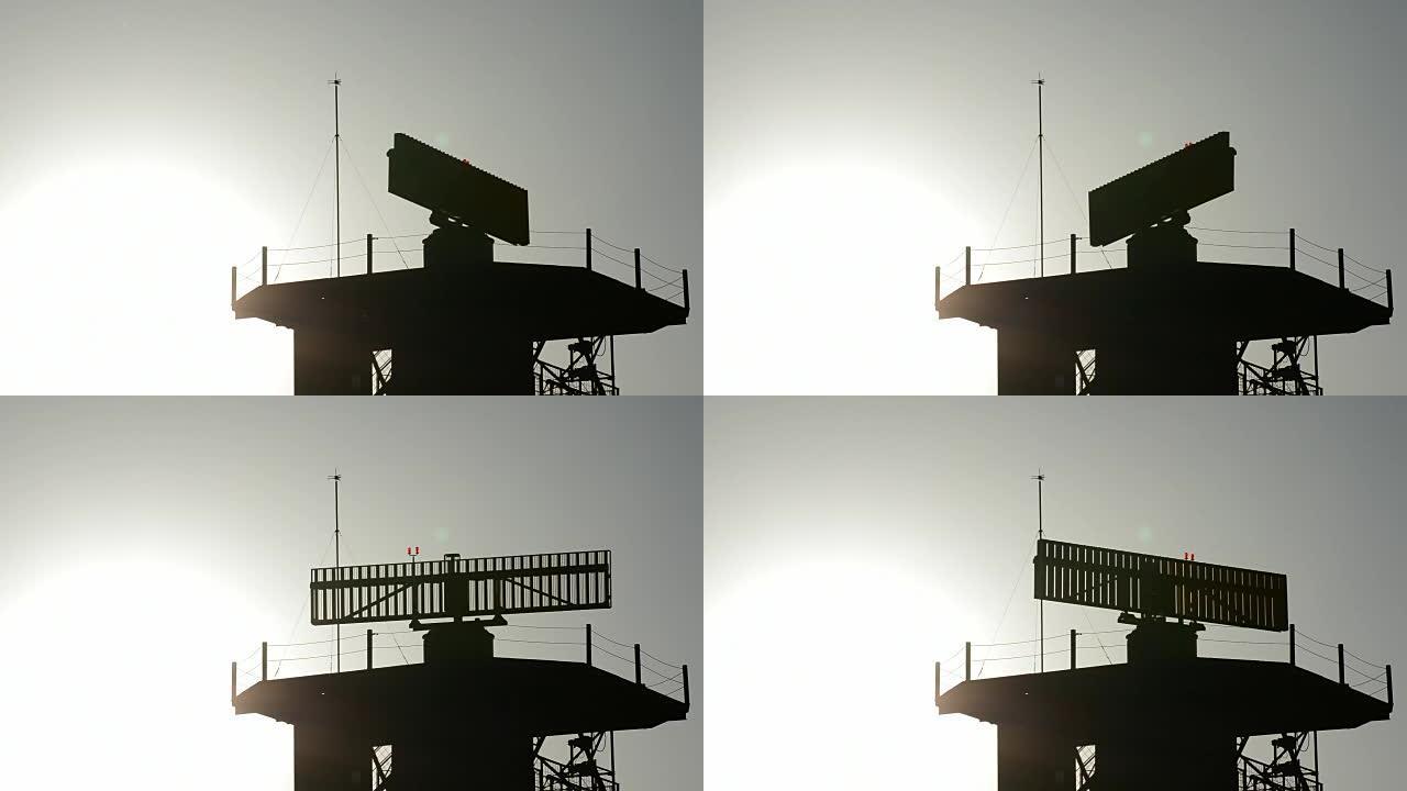 日落时在机场的雷达旋转塔