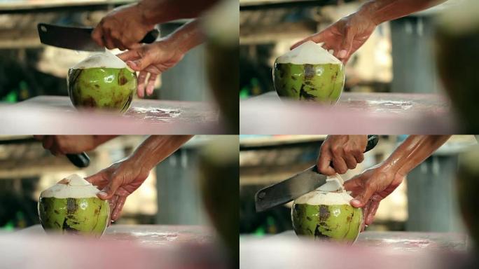 一个人用大刀打开椰子。