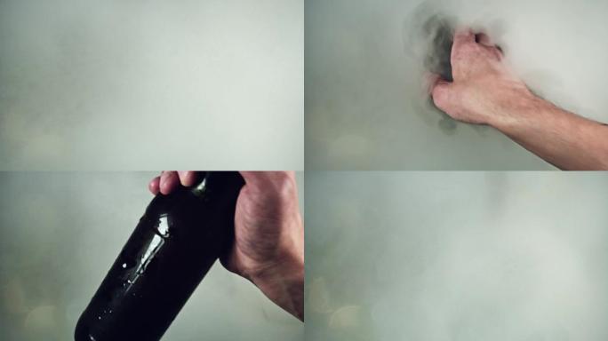 4k拍摄冷冰块和手从雾中抓取啤酒瓶