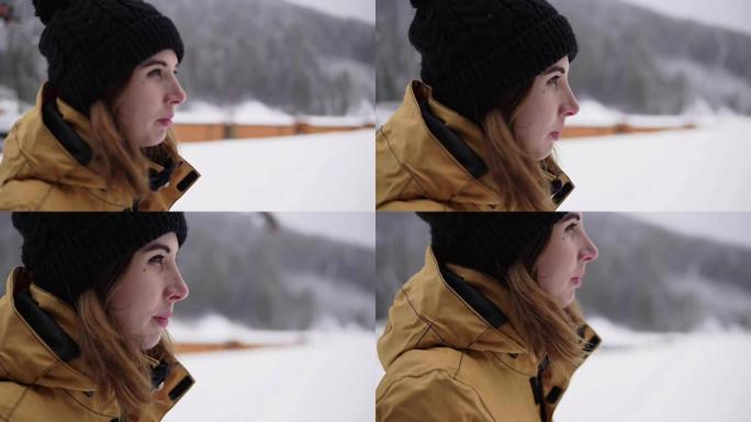 下雪期间，年轻女子在冬季滑雪胜地散步的特写镜头