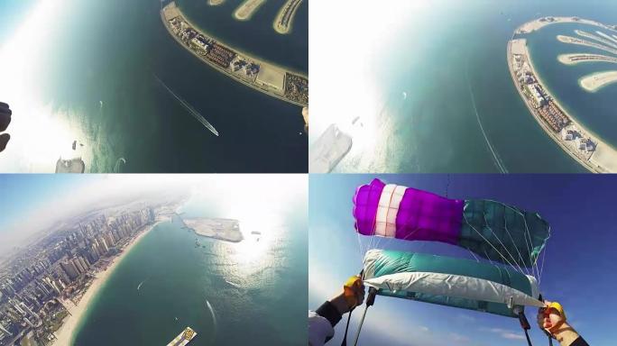 专业跳伞运动员在迪拜海岸上空跳伞。极。海洋。城市