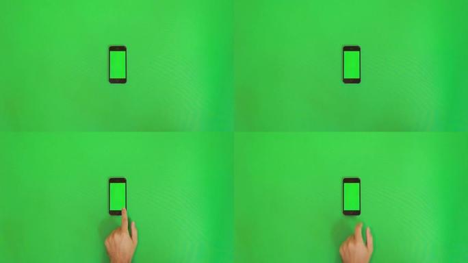 智能手机在绿色屏幕上滑动手势。垂直