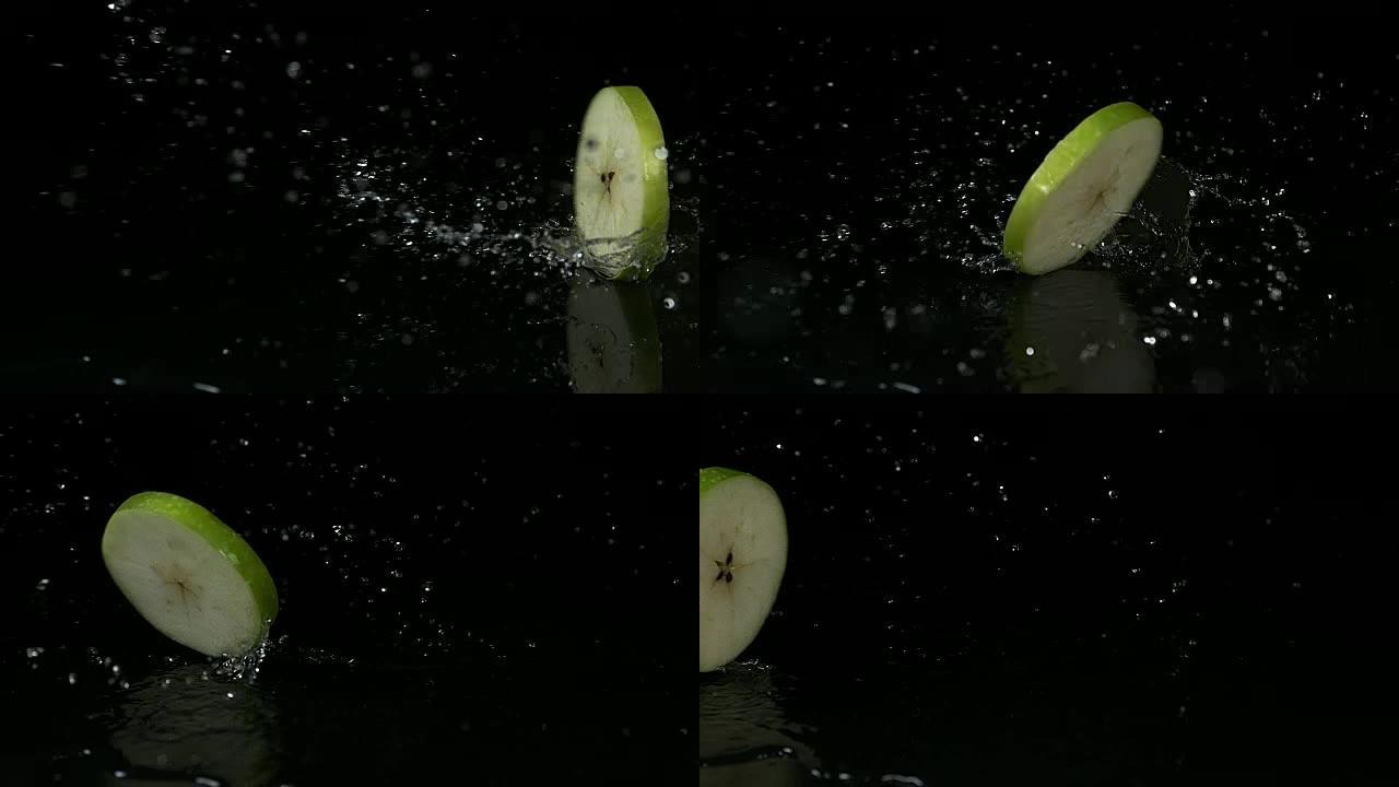 奶奶史密斯苹果，苹果苹果，切片在黑色背景下打开水，慢动作4K