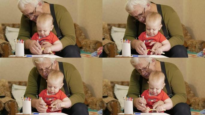 有吸引力的婴儿画与他的祖父在纸上的标记。孩子过敏，眼睛发红。孩子1年