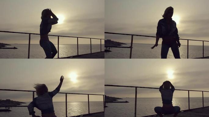 身材性感短发的女孩在日落时在海边的码头上跳舞