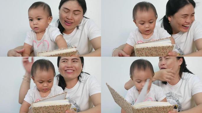 亚洲宝宝和妈妈一起玩耍和看书