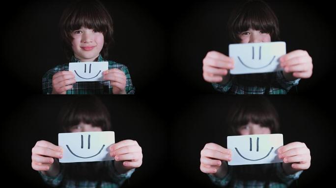 4k可爱的孩子手握在纸上笑脸