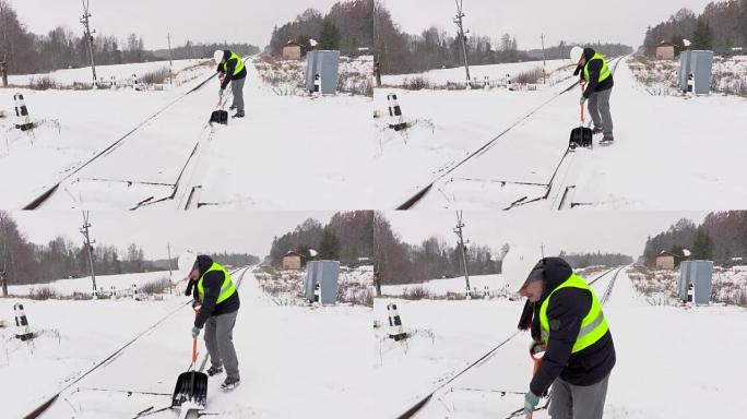 铁路员工清洁铁路道口的积雪