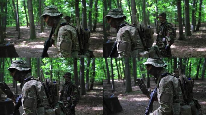 游击战士班长在森林的灌木丛中指导他的战士