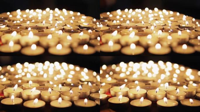 许多装饰蜡烛在黑暗中燃烧