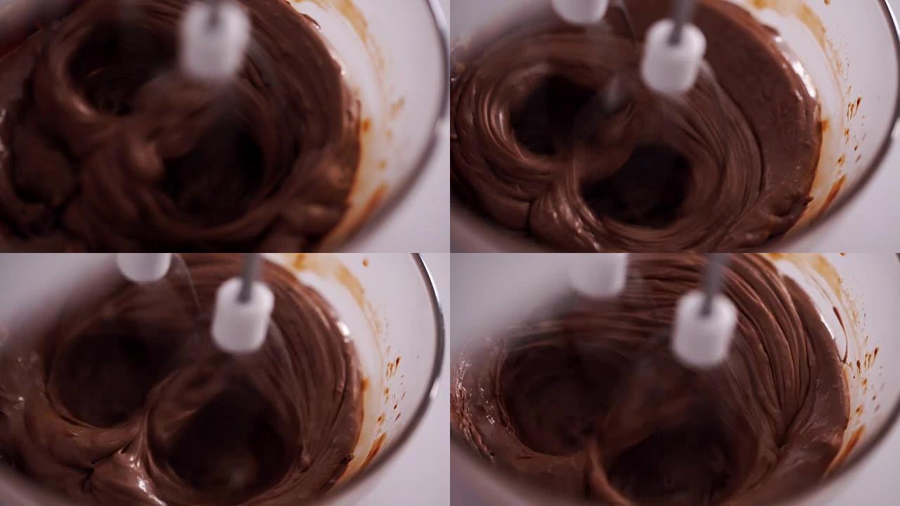 自动搅拌器搅拌巧克力蛋白块。巧克力面团。
