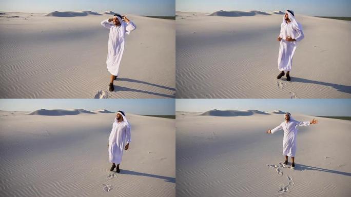 快乐的穆斯林阿拉伯阿联酋酋长盖伊在晴朗的夏日里面带微笑地走过广阔的沙漠