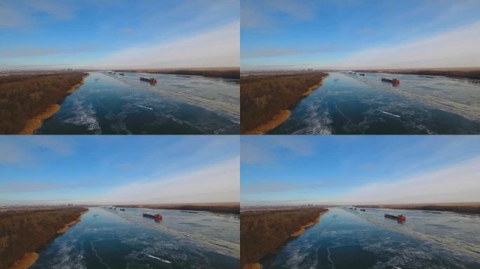 美丽冰冻河流中的货船。
