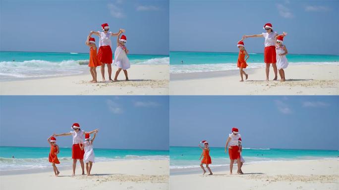 海滩圣诞假期戴着圣诞老人帽子的小女孩和年轻母亲