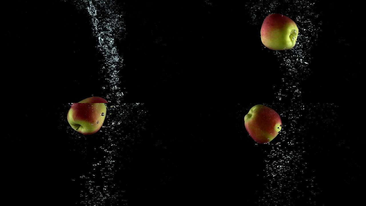 黑色背景下落水的单个苹果。超级慢动作