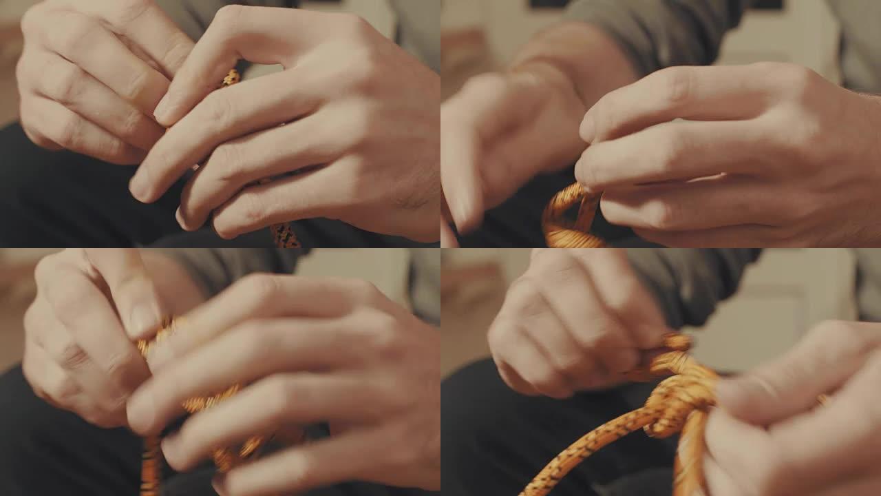 男人的手在绳子上系一个登山结