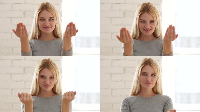 年轻女子用双手邀请顾客的肖像